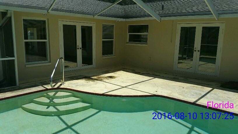 Pressure washing pool deck before picture