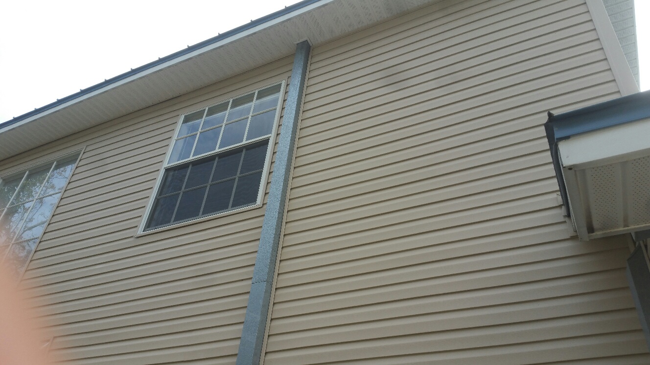 Power washing house siding after